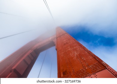 Golden Gate Bridge Tower In The Fog. Unique Perspective Looking Up From The Base, With A Close Up View Of The Rivets. Copy Space