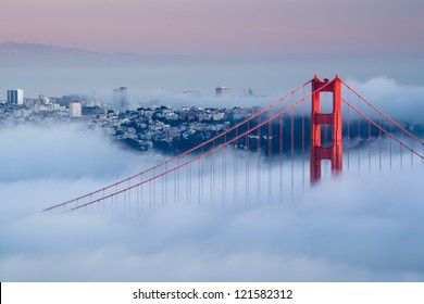 Golden Gate at dawn surrounded by fog