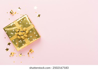 Golden gift boxes and confetti on color background, top view - Powered by Shutterstock