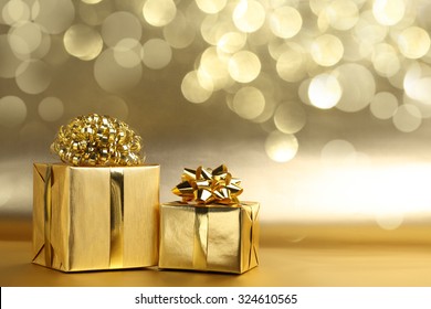 Golden gift boxes on abstract background - Powered by Shutterstock