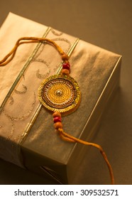 A Golden Gift Pack With Rakhi String,