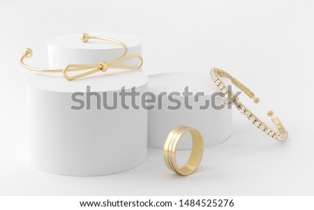 Golden girl accessories two golden bracelets and ring on white background