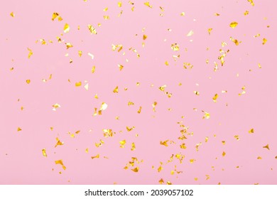 Golden glitter confetti sparkles on pastel pink background. Flat lay, top view. Holiday, festive, party backdrop - Shutterstock ID 2039057102