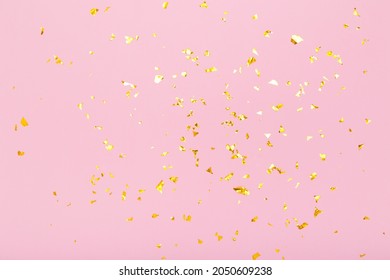 Golden glitter confetti sparkles on pastel pink background. Flat lay, top view. Holiday, festive, party backdrop - Shutterstock ID 2050609238
