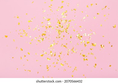 Golden glitter confetti sparkles on pastel pink background. Holiday, festive, party backdrop. Flat lay, top view, copy space. - Shutterstock ID 2070566432