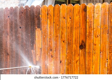 Golden Grain Comes Out After The Dirty Is Removed By Pressure Washing Wooden Fence In Suburb Neighborhood During Stay At Home Orders For Covid-19 Lockdown Cleaning Surfaces And Home Repairs