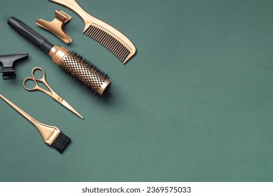 Golden hairdressing tools scissors combs on green background. Horizontal template with hair salon accessories and copy space. - Powered by Shutterstock