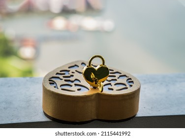 Golden Heart Shaped Love Padlock And Key Over On Gold Heart-shaped Box. Valentine's Day Concept, Copy Space, Selective Focus.