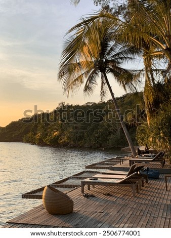 Golden hour in the Bang Bao bay in Koh Kood with coconut trees