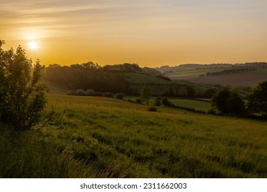 Golden hour during sunrise over the rolling hills of the Dutch province of Limburg near the village of Fromberg (English: Fromberg), a typical region for agricultural activities - Powered by Shutterstock