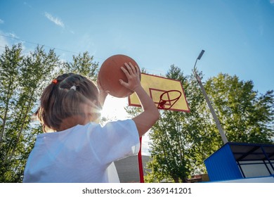 Golden Hour Glory: A Girl's Basketball Passion Shines Bright in the Sunset - Powered by Shutterstock