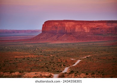 Golden Hour Glow on Monument Valley Mesa with Winding Road - Powered by Shutterstock