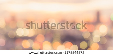 Golden hour sky with city rooftop view blur background with cityscape business corporate office building landscape blurry twilight night lights skyline nightlife bokeh for evening party 
