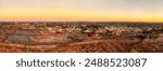 Golden hour sun light over Silver city Broken Hill in scenic aerial panorama of Australian outback mining industry.