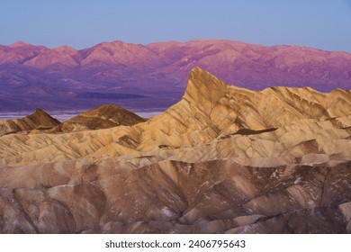 Golden hour sunrise over layered mountain rock formations at Zabriskie Point Death Valley National Park California - Powered by Shutterstock