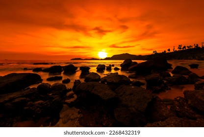 Golden hour sunset. Orange sunset at seaside with rocks - Powered by Shutterstock