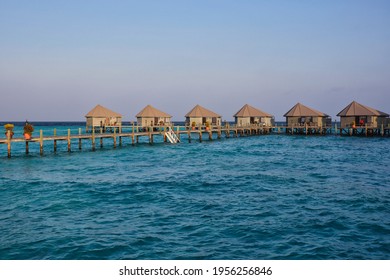 Golden Hour View of Water Villas in Maldives. Overwater Bungalow, Wooden Pier and Laccadive Sea in Maldivian Resort. - Powered by Shutterstock