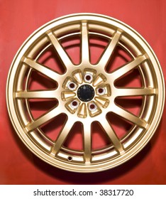 a golden hubcap isolated over red background
