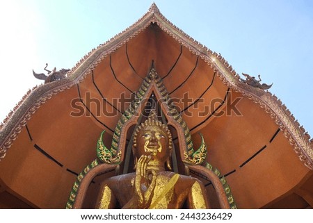 Golden huge Buddha statue is located on the top of the mountain in Thailand