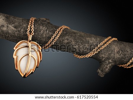 Golden Jewelery pendant as leaf on branch