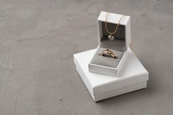 Golden Jewellery In Box On Gray Background