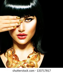 Golden Jewellery. Gold Jewelry. Beauty Brunette Egyptian Style Woman with Gold Accessories and Nails. Golden Nail Polish and Necklace