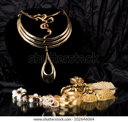 Golden jewelry on black background