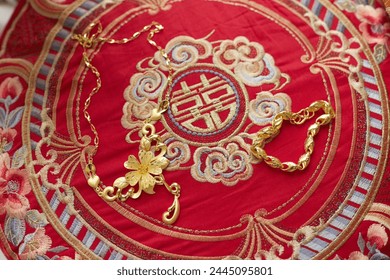 Golden jewelry on embroidered traditional Chinese wedding textile - Powered by Shutterstock