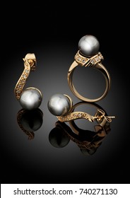 Golden Jewelry Set With Pearls On Black Background