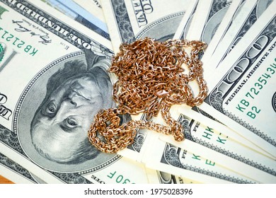 golden jewelry and stack of money, pawnshop concept, closeup