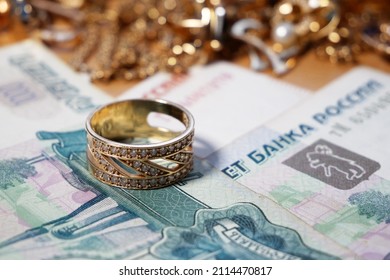 golden jewelry and stack of money, pawnshop concept, closeup