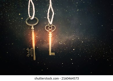 Golden key with glowing lights and dark background, wisdom, wealth, and spiritual concept - Shutterstock ID 2160464573