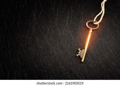 Golden key with glowing lights and dark background, wisdom, wealth, and spiritual concept - Shutterstock ID 2161903519