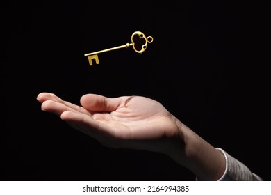 golden key in hand, the key to success and wealth, new opportunities and good luck in business - Powered by Shutterstock