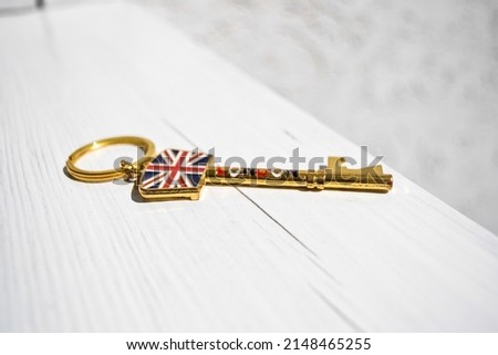 Golden key with a ring and the British flag and the inscription London