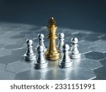 Golden king chess piece standing in the center of little silver pawn pieces on hexagon pattern floor background. Games of chess figure in chess game competition. Leadership, business strategy concept.