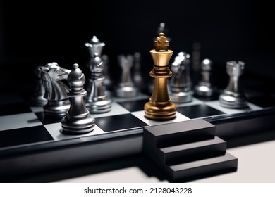 Golden King Chess Surrounded By Enemy And Checkmate For End Game, But He Has Emergency Exit Stairs Prepare For Worst Case Scenario. Business Strategy And Life Planning Concept.