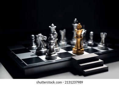 Golden king chess surrounded by enemy and checkmate for end game, But he has emergency exit stairs prepare for worst case scenario. Business strategy and life planning concept.
