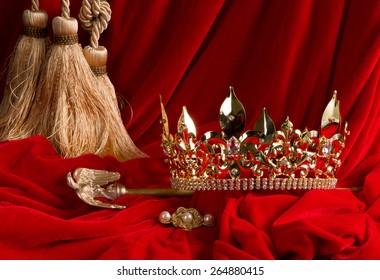 Golden king's crown and scepter on red velvet - Shutterstock ID 264880415
