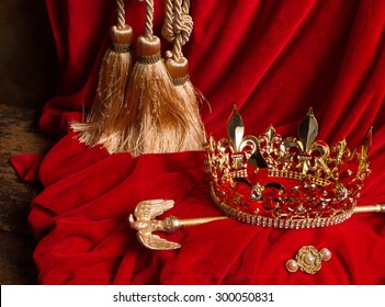 Golden King's Crown And Scepter On Red Velvet