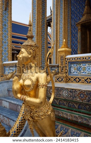 Golden Kinnari a mythological  figure, in Wat Phra Kaew, the Grand Palace Bangkok, Thailand.
