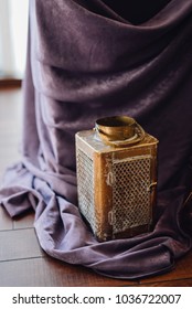 Golden lantern standing near reception table covered with violet cloth. Reception. Deocr