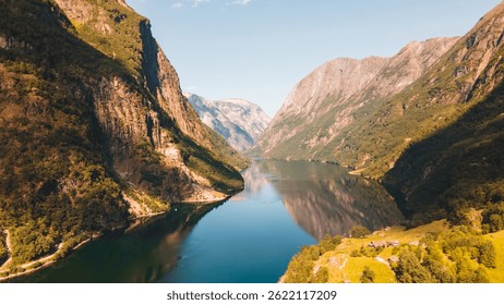 Golden light over dramatic cliffs of Geirangerfjord, Norway