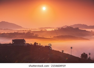 Golden light and Sea of Mist in the morning from viewpoint at Khao Kho, Khao Kho District, Phetchabun, Thailand. A scenic view of  hill covered with mist during the golden hour