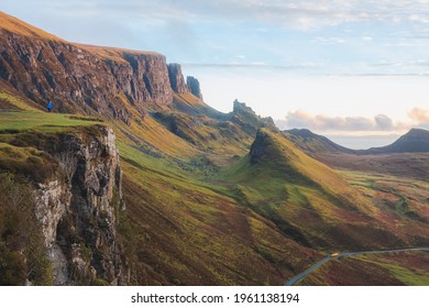 Golden light at sunset or sunrise over colourful landscape view of the rugged, otherworldly terrain of the Quiraing on the Isle of Skye, Scotland.
