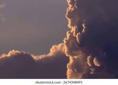 Golden light transforms a dramatic sky full of beautiful, fluffy clouds.
