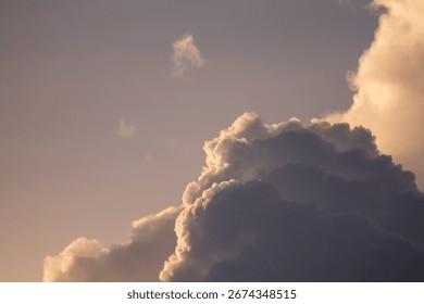 Golden light transforms a dramatic sky full of beautiful, fluffy clouds.