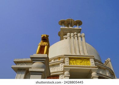 golden lion in dhauli shanti stupa