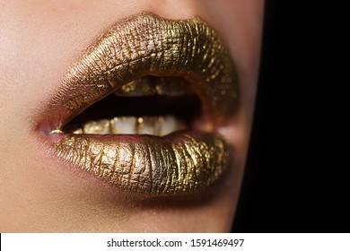 Golden lips close up. Golden lips on beautiful model girls mouth. Make-up. Beauty makeup close up. Golden make up in lips. Gold concept