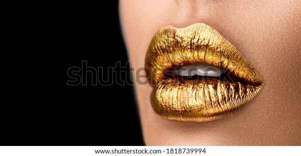 Golden
lipstick closeup. Metal gold lips. Beautiful makeup. Sexy lips,
bright paint on beautiful model girl's mouth, close-up. Metallic
Lipstick closeup. Isolated on black
background